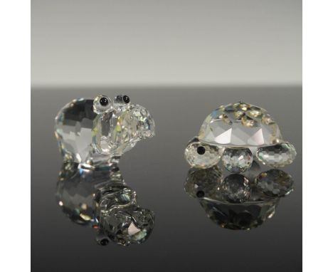 This lot features two retired Swarovski crystal animal figurines crafted with precision cut clear crystal. Included is one sm