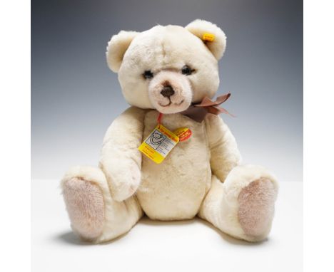 Charming vintage Steiff plush teddy bear, Petsy. This soft cream colored bear features brown facial and paw accents, a brown 
