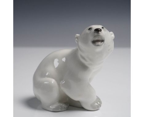 Delicately modeled porcelain figurine of a seated polar bear, finished in a smooth white glaze with finely painted features a