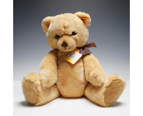 Vintage Steiff plush bear, model "Pepsy," featuring soft golden mohair fur, stitched nose and mouth, and original brown ribbo