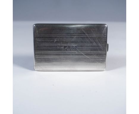 Marked sterling, this rectangular silver case features an elegant engine-turned design finely machined, repetitive lines that