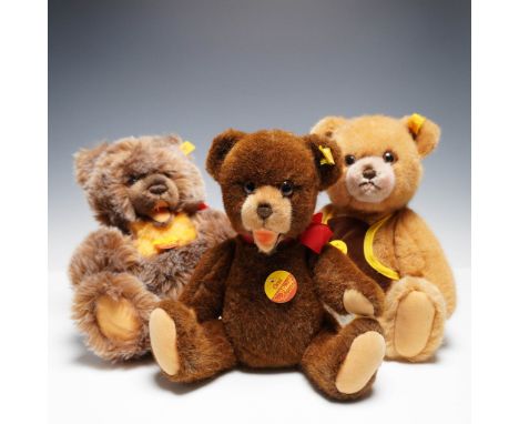 Three-piece collection of authentic Steiff teddy bears, each with the signature "button in ear" and yellow tag identifiers. I
