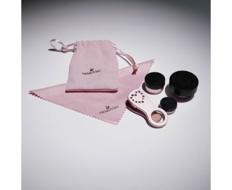 A Swarovski crystal smartphone photography accessory set featuring a pink metal clip-style lens holder accented with embedded