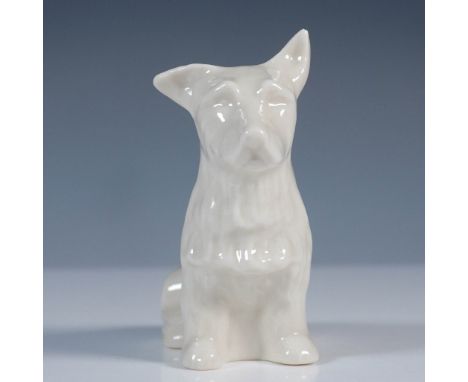 This Irish Belleek porcelain figurine features a seated Scottish Terrier in a creamy white glaze, known for its delicate tran