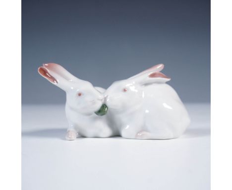 Royal Copenhagen porcelain figurine depicting a pair of white rabbits tenderly touching noses, sharing a green leaf. Model 51