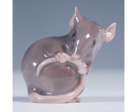 Crafted by the renowned Danish porcelain manufacturer Bing &amp; Grondahl, this charming figurine depicts a curled mouse clut