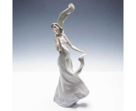 This Lladro Premier Collection figurine, Wind of Peace, captures the elegance of a graceful woman in motion, her long gown an