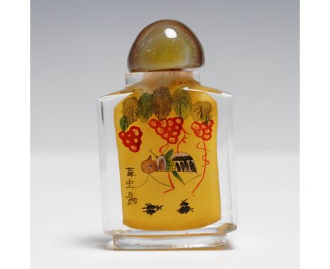 Reverse painted snuff bottle featuring a vibrant scene of insects, including a bee and praying mantis, surrounded by red frui