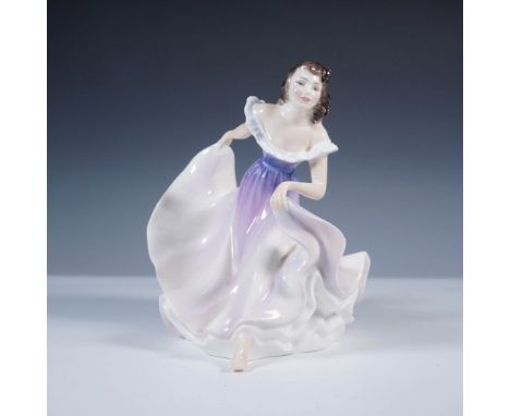 This hand-painted figurine features a graceful dancer in mid-motion, with a flowing ruffled dress in soft lilac and white hue