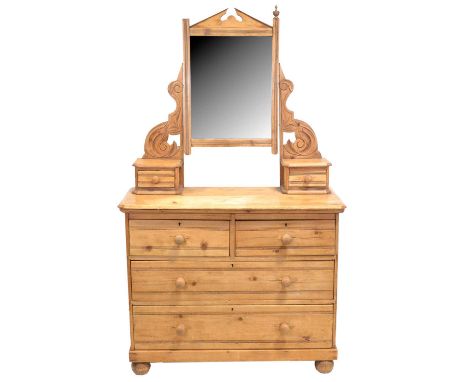 Edwardian stripped pine dressing table, rectangular bevelled mirror supported by scrolled brackets, with two trinket drawers,