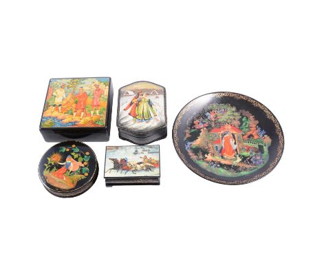 Four Russian black lacquer Fedoskino boxes, painted with figural scenes, post-1945, and a similar ceramic plate, 19cm.