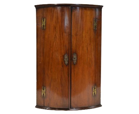 George III mahogany cylinder front hanging corner cupboard, moulded cornice, interior with three shelves, width 69cm, depth 4