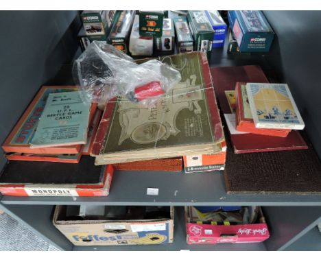 A shelf of vintage games including an original Frederick Warne &amp; Co Ltd Peter Rabbit Race Game with three original lead f