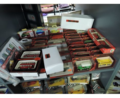 A shelf of Matchbox Models of Yesteryear, EFE and similar diecast Buses and Advertisng Vans, all in window display boxes, app