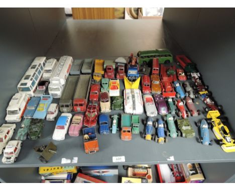 A shelf of Dinky playworn diecasts including Racing Cars, Police Vans, 8 Wheel Wagons also seen, clockwork Mettoy Bus, Polist