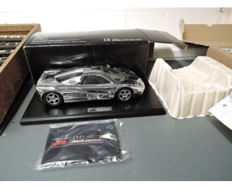 A Gwilo International Limited 118 scale diecast model, F1 McLaren 1993 Sports Car, on plastic stand and in original box