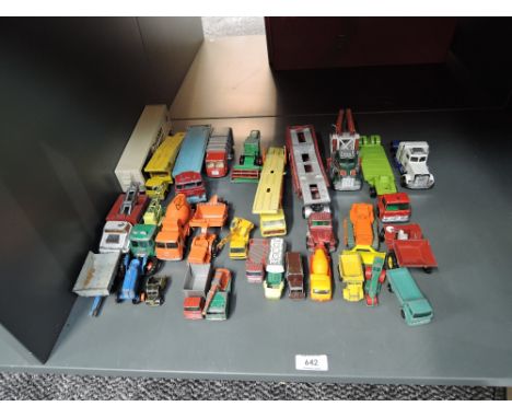 A shelf of Matchbox playworn diecasts including Construction, Car Carriers etc