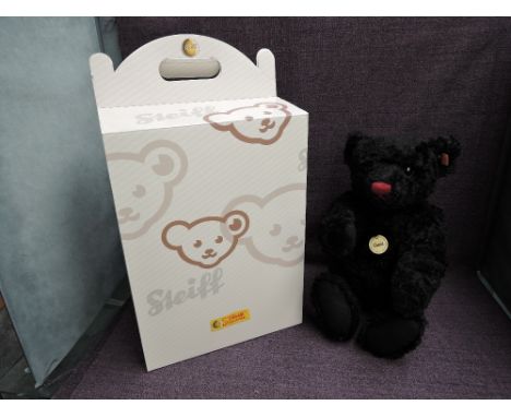 A modern Steiff Black Bear 005985 with yellow tag and button, growling mechanism and boxed,