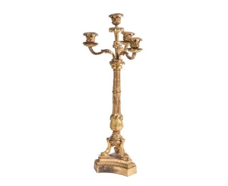 A French ormolu four light candelabra, late 19th century, with scrolling foliage and strapwork decoration, dolphin feet, 52cm