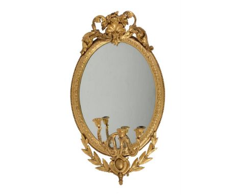 A pair of Victorian giltwood and composition girandole oval wall mirrors with three candle branches, circa 1880, in the manne