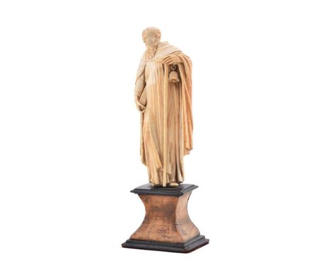 Y A carved ivory model of a saint, Probably Antony the Great, 17th century, probably Dieppe, portrayed holding his attributes