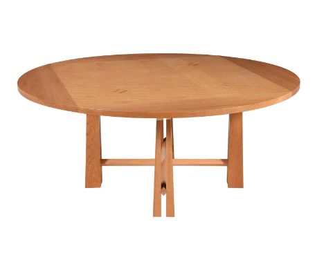 A light oak and maple dining table, of recent manufacture, the circular top above the supports and stretchers, 74cm high, 165