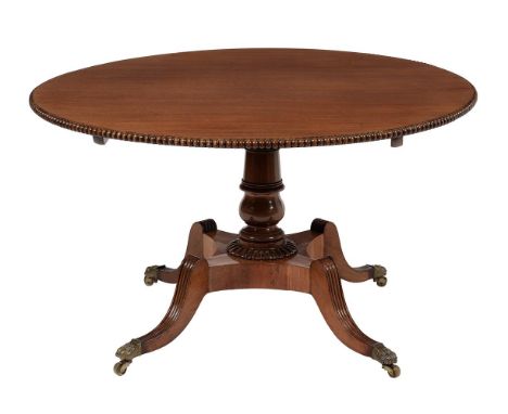 A Regency mahogany centre table, circa 1820, almost certainly Scottish, with bead moulding to the edge, above a turned pillar