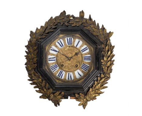 A French ebonised and gilt metal mounted dial wall clock, 19th century, the frame with wreath decoration, 56cm diameterCondit