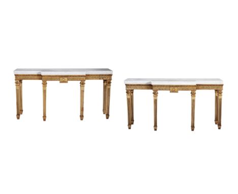 A pair of mahogany and parcel gilt console tables in George III style, mid 20th century, each of breakfront outline, the vari