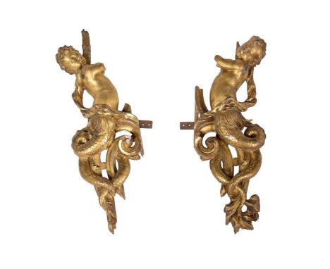 A pair of carved giltwood mounts, 19th century, modelled opposing, each as putti with scaled fish tails, 72cm high, 27cm wide