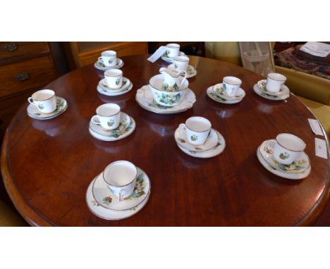 A Staffordshire c1910 hand painted tea set with floral pattern and gilded rims including cups, saucers, side plates, sucrier,