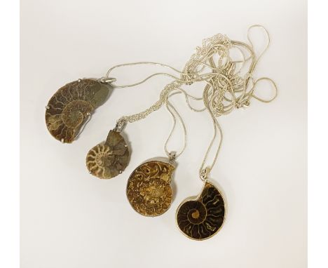 FOUR AMMONITE MADAGASCAN PENDANTS ON CHAIN