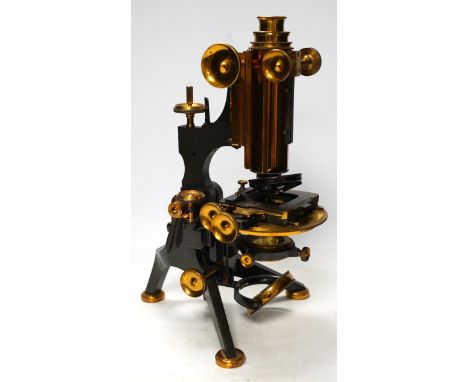 A late 19th/early 20th century brass microscope, by Watson and Sons, in a fitted case with some alternative lenses and other 