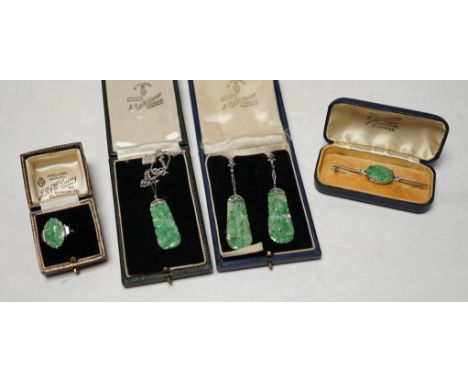A cased 1930's white metal, single stone carved jade and two stone diamond set bar brooch, 62mm, a similar 9ct and carved jad
