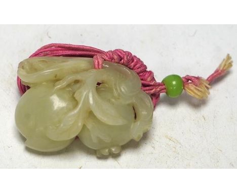 A 19th century jade carving of fruit, 5.5cm wide. Condition - fair, a small piece missing Small area of loss to foliage. Some
