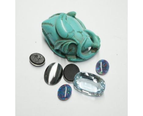 A turquoise carving and a small group of unmounted stones including opal doublets and chatoyant and a blue topaz. Condition -