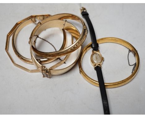 A lady's modern 14k Omega manual wind wrist watch and five assorted metal bangles. Condition - poor to fair