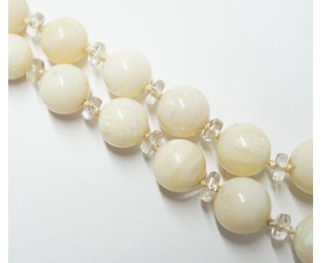 A single strand graduated white opal circular bead necklace, with paste? spacers and white metal clasp, 58cm. Condition - fai