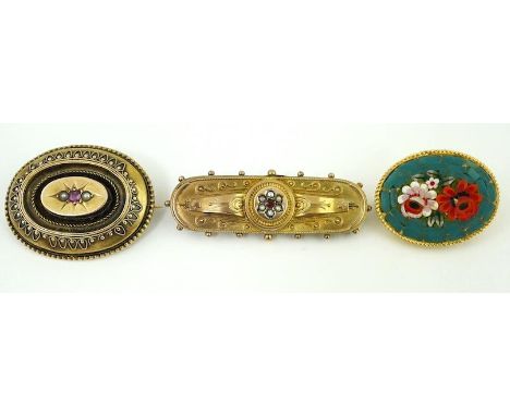 Two late Victorian yellow metal, ruby and seed pearl set brooches, largest 46mm, gross weight 10.9 grams and one other costum