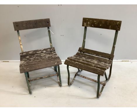 A pair of vintage slatted wrought iron garden chairs, width 45cm, depth 45cm, height 76cm. Condition - fair