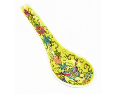 A 19th century Chinese Famille Rose spoon painted with a butterfly and floral sprays on a yellow ground, unmarked, length 13.