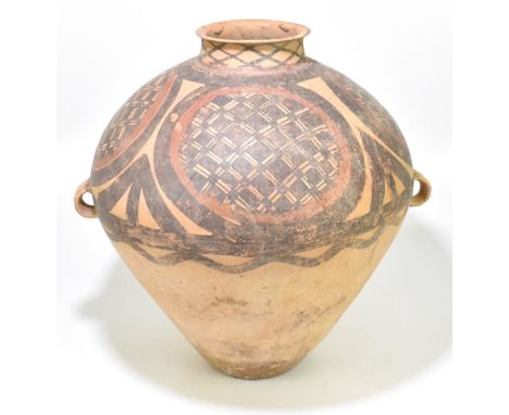 A large Chinese Neolithic period (circa 2nd Millennium BC) Yangshao Culture buff red earthenware twin handled jar with painte