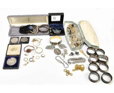 A group of costume jewellery to include two silver bangles, bead necklaces and brooches.