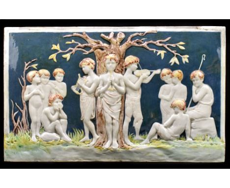 EMILY M. WOOD FOR DELLA ROBBIA; a large earthenware glazed tile decorated with child musicians beside a tree, incised mark to