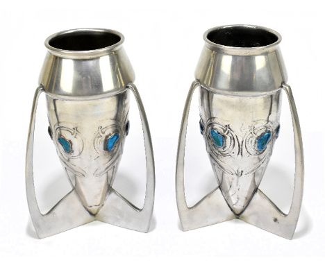 ARCHIBALD KNOX FOR LIBERTY & CO; a pair of pewter and enamel rocket vases, each set with six heat shaped enamelled plaques an