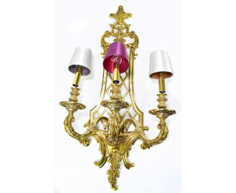 A large gilt metal wall light, the pierced shaped backplate supporting three scrolling arms, length 97cm.