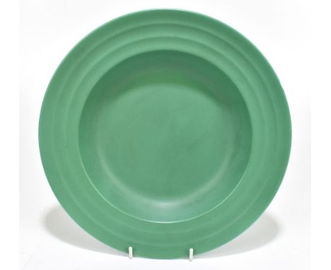 WEDGWOOD; a matt green footed bowl with ribbed linear decoration in the manner of Keith Murray, diameter 27cm.Additional Info