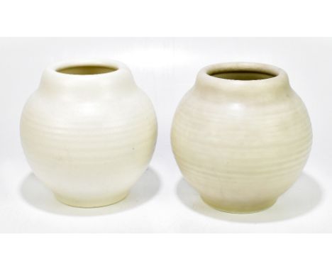 ROYAL LANCASTRIAN; a pair of bulbous vases with ribbed decoration, one example thrown by Edward Thomas Radford, height 17cm (