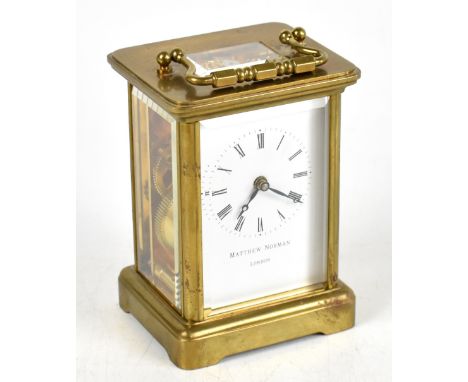 MATTHEW NORMAN; a modern lacquered brass carriage time piece, the enamel dial with Roman numerals, height with handle down 11