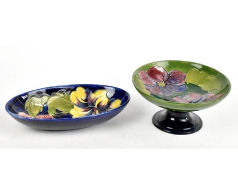 MOORCROFT; an oval bowl decorated in the 'Hibiscus' pattern on a blue ground, width 23cm, together with a Moorcroft tazza dec